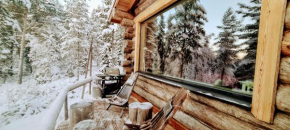 Log cabin in Lapland by the river